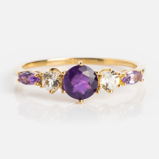 The Solid Gold 2025 February Capsule Amethyst Statement Set showcases an oval amethyst birthstone, accented by clear and small purple stones, and comes with a free gift.