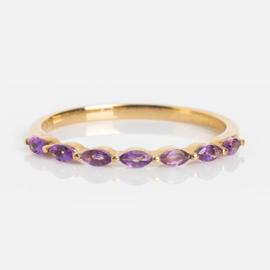 The Solid Gold 2025 February Capsule Delicate Amethyst Stacking Ring features seven marquise-cut purple gemstones, perfect as a stylish birthstone ring or stacking piece, displayed on a white background.
