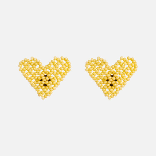 Two Dae Earrings by Casa Clara, featuring small yellow beads with a subtle central pattern of darker yellow beads, are displayed on a plain white background.