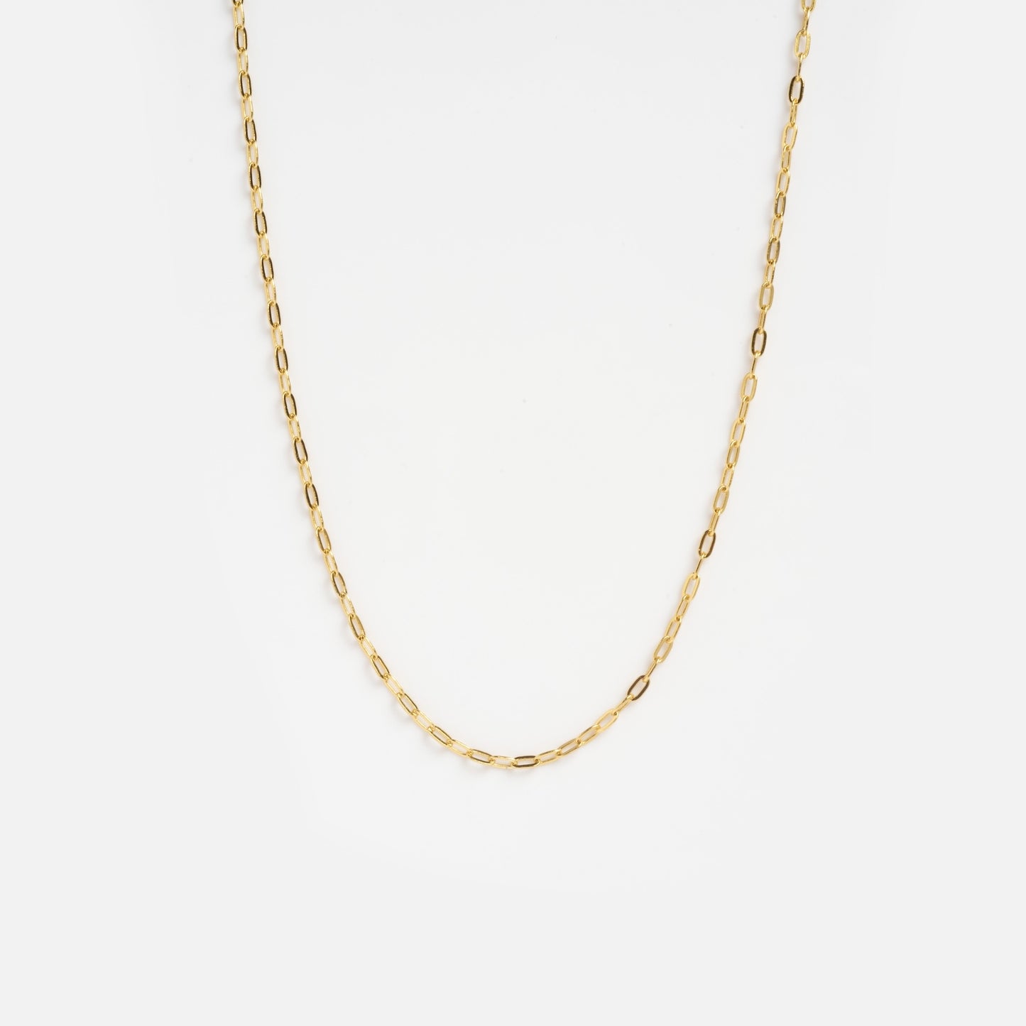 The Vermeil Paperclip Chain Sample is a delicate gold necklace featuring small, elongated oval links, shown against a plain white background.
