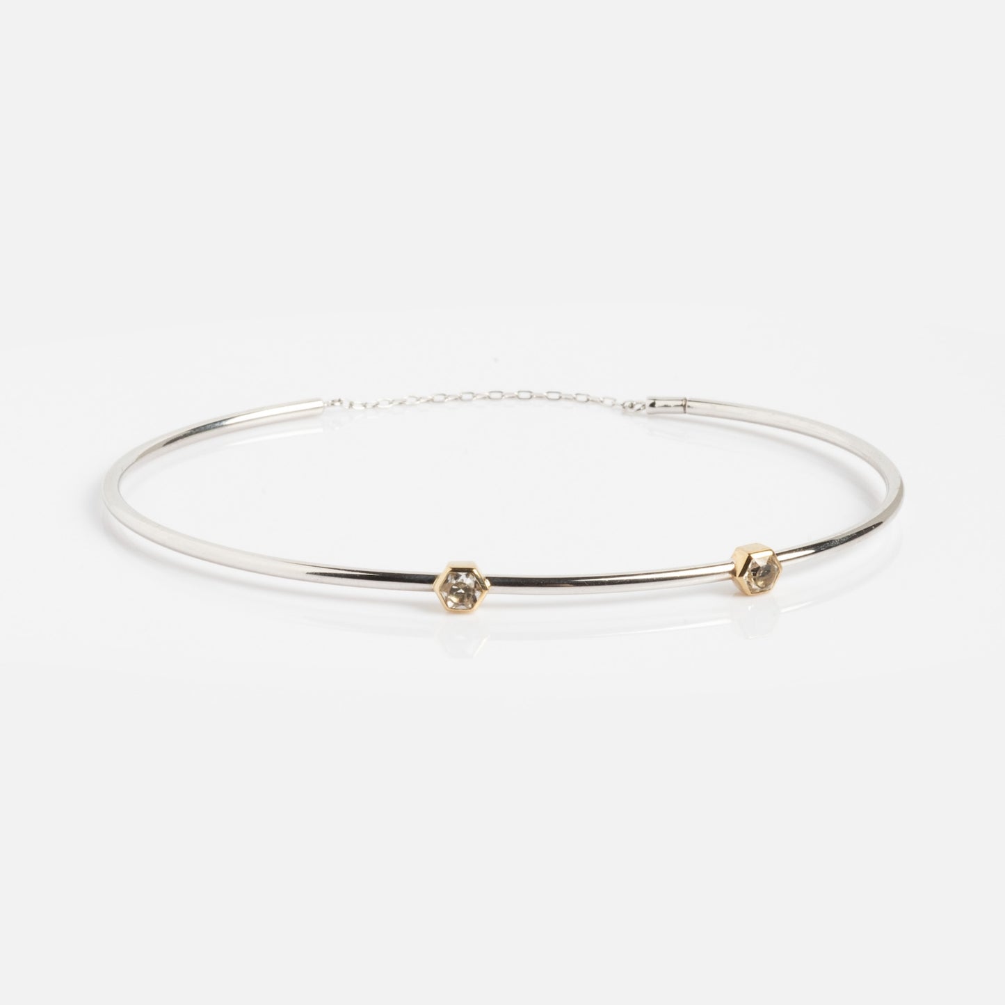 A minimalist Solid Gold White Gold Bracelet Sample, featuring a sleek design and displayed on a white background.