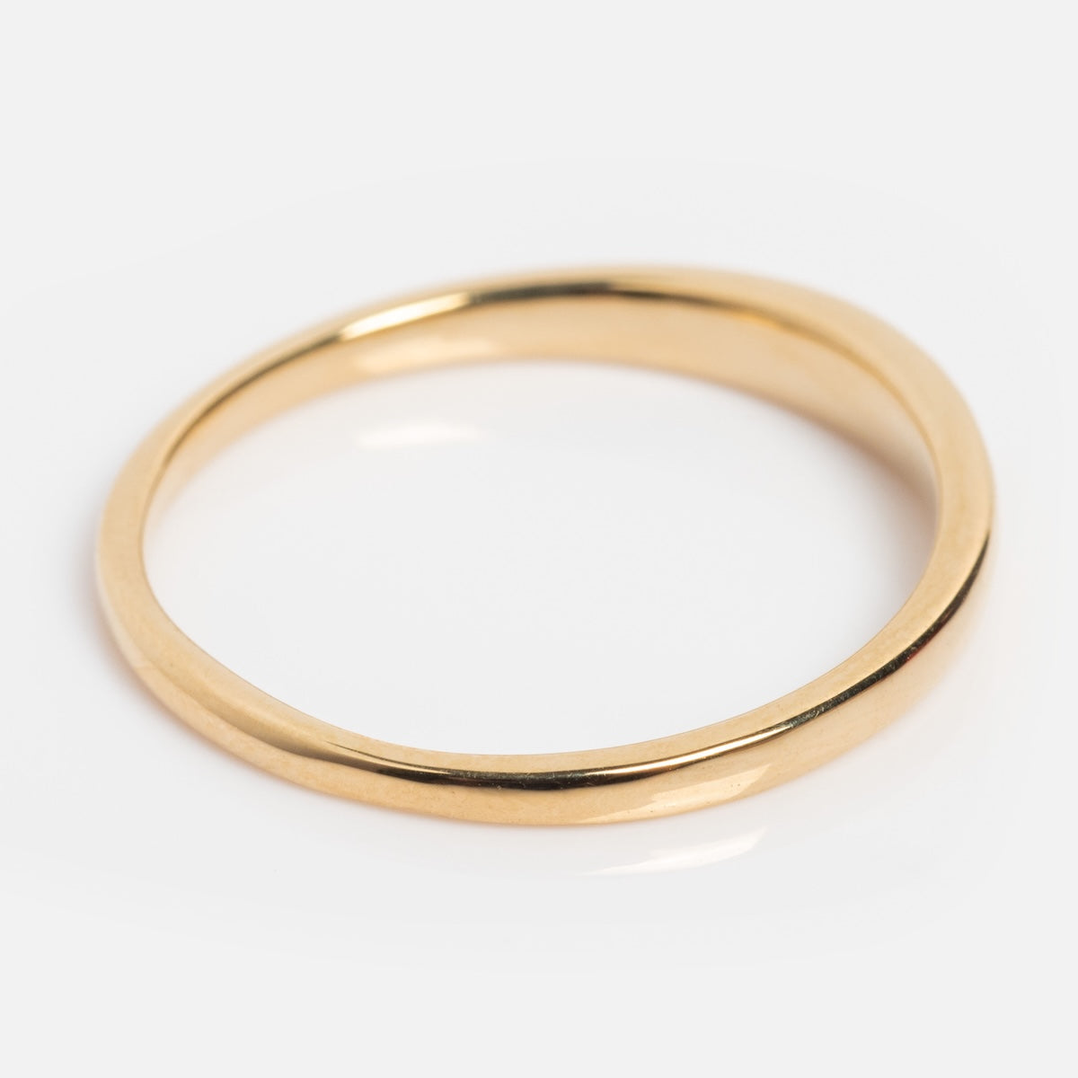 The 14k Till Death Layering Ring from Charlie and Marcelle is a simple, thin gold band with a smooth, polished finish, shown on a white background.