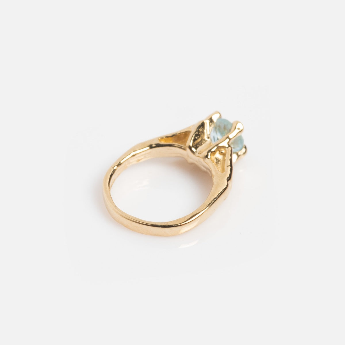 The 14k Littlest Birthstone Ring Charm features a prominent light blue gemstone in a raised prong setting, displayed against a plain white background.