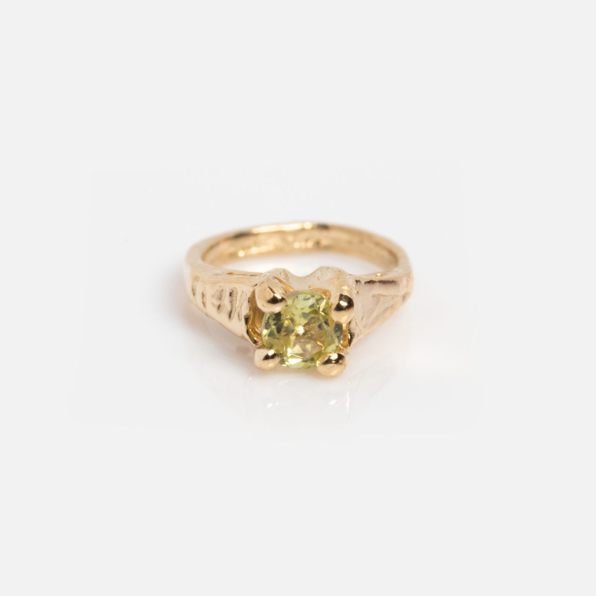The 14k Littlest Birthstone Ring Charm by Charlie and Marcelle features a textured gold band with a single round yellow gemstone in four prongs—perfect as a birthstone ring charm or a solid gold necklace charm.
