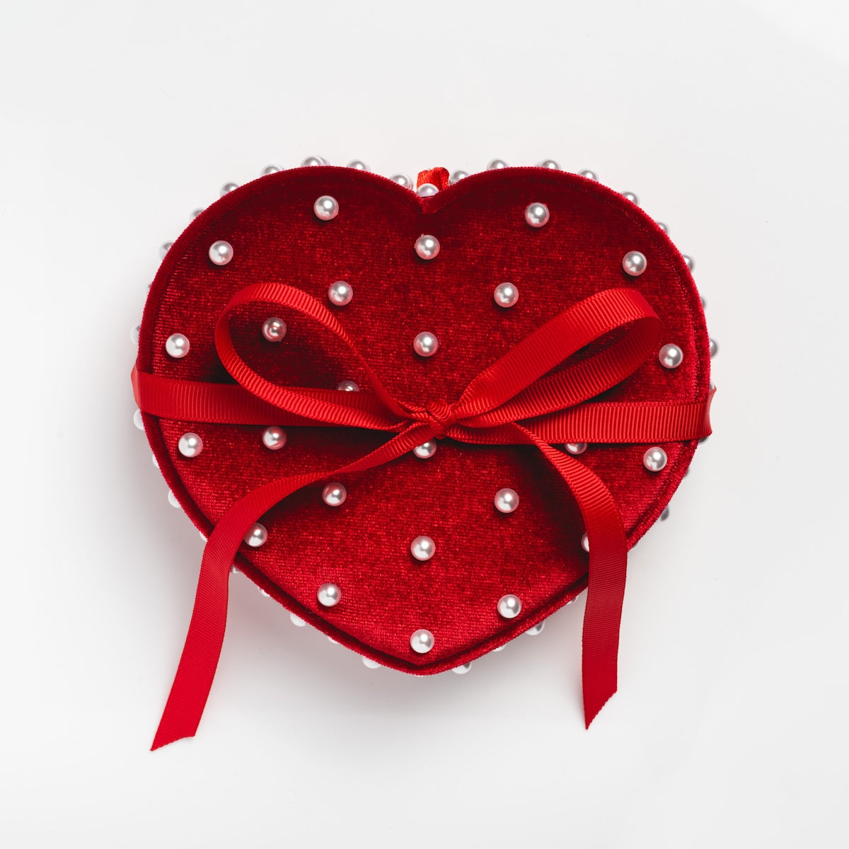 The Valentine's Day Solid Gold Hearts Gift Set Sample features a red velvet heart-shaped jewelry box with pearl-like beads and a ribbon bow—ideal for presenting 9k solid yellow gold or white topaz necklaces.