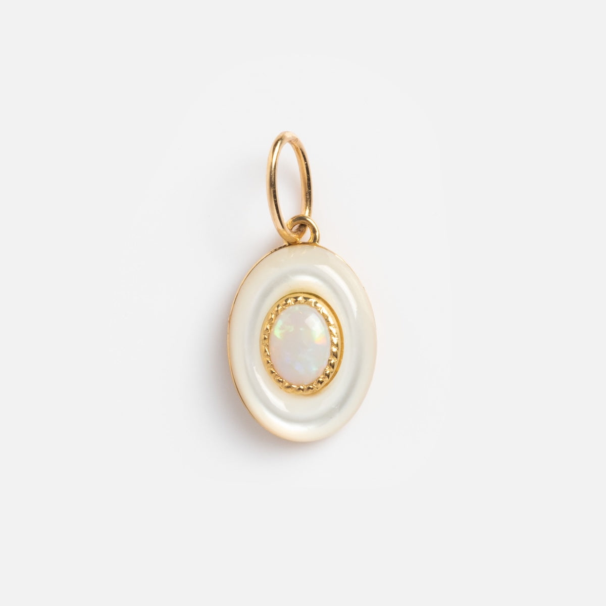A round solid gold pendant features a central pink opal, bordered by a white enamel ring and gold rim, attached to a gold jump ring. Product: Solid Gold Modern Pink Opal Charm Sample. Displayed against a plain white background.