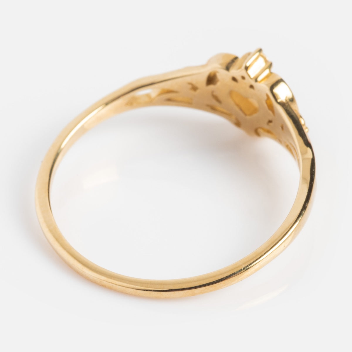 A close-up of the Solid Gold Openwork Filigree Opal Heart Ring, featuring a thin band and ornate openwork setting, photographed from the side against a white background.