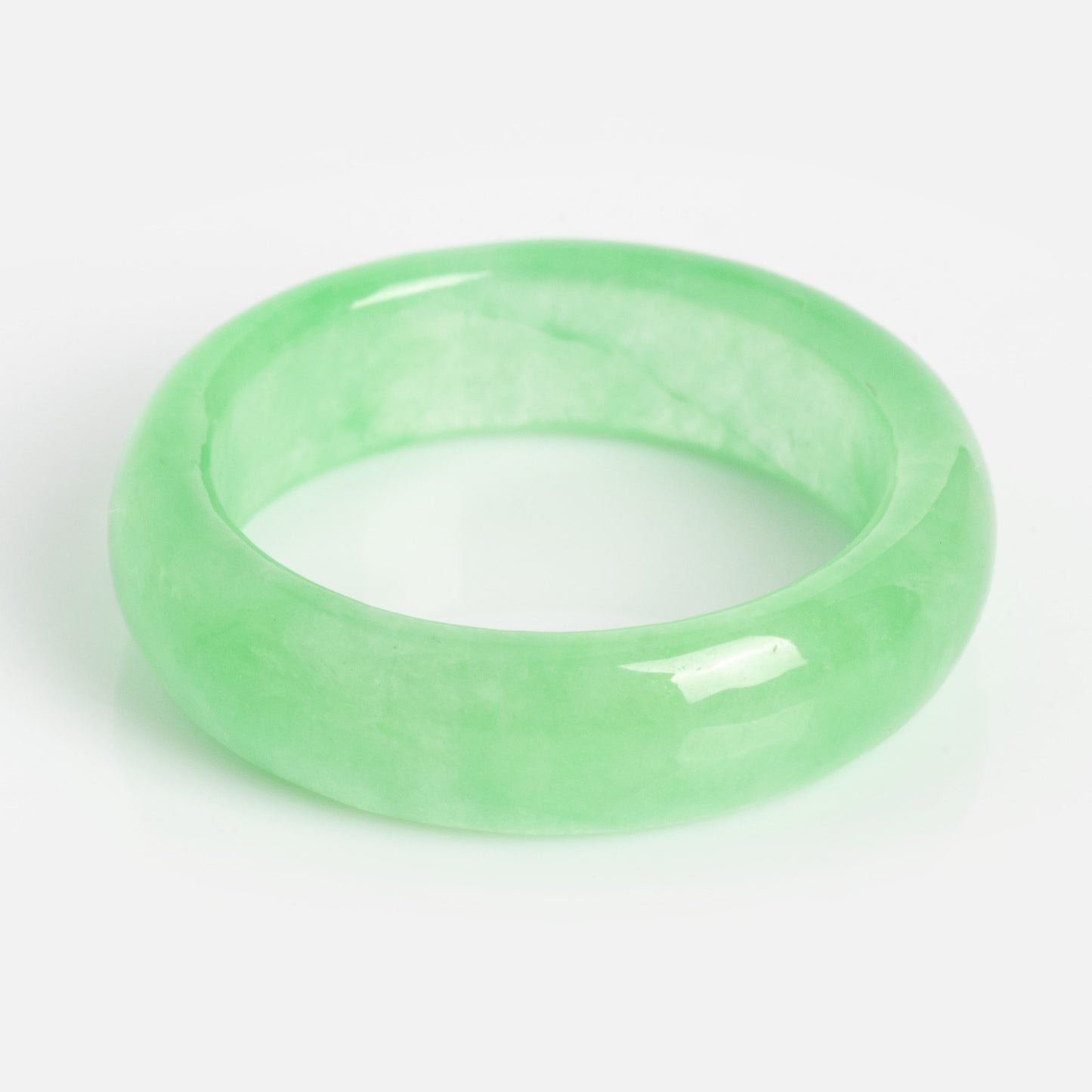 The ZZ Imperial Green Jade Ring features a glossy, translucent light green jade with a smooth, rounded finish and a 5 mm band width, shown on a plain white background.