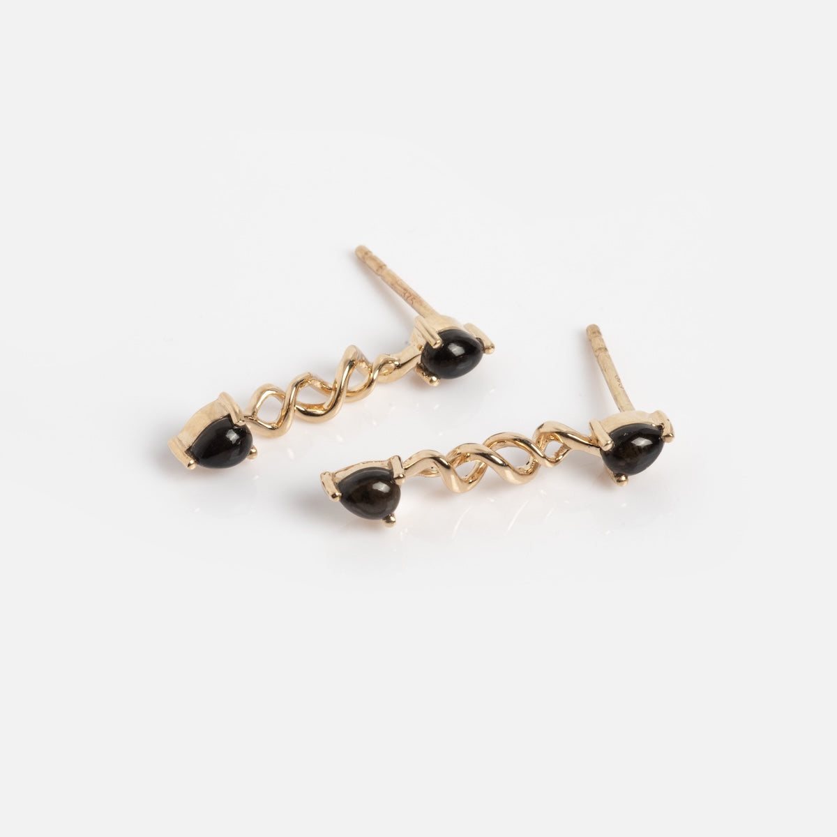 The Solid Gold Black Obsidian Earrings Sample are 9k solid gold stud earrings with twisted metal designs and Black Obsidian accents at the ends, shown on a white background.