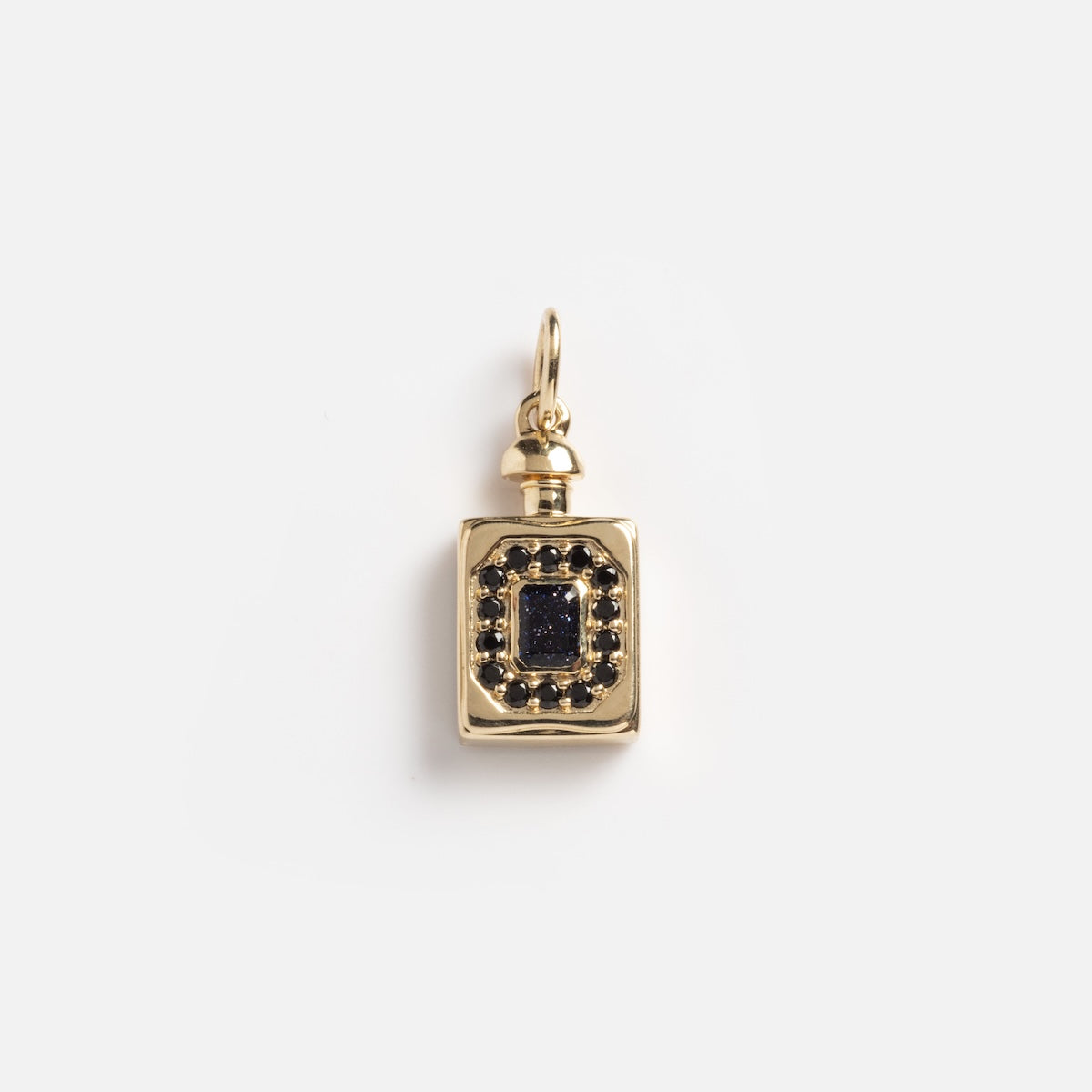 The Solid Gold Gemstone Flask Charm Sample is a gold rectangular pendant featuring a central black gemstone, surrounded by small black stones, with a small loop at the top for attaching to a chain.
