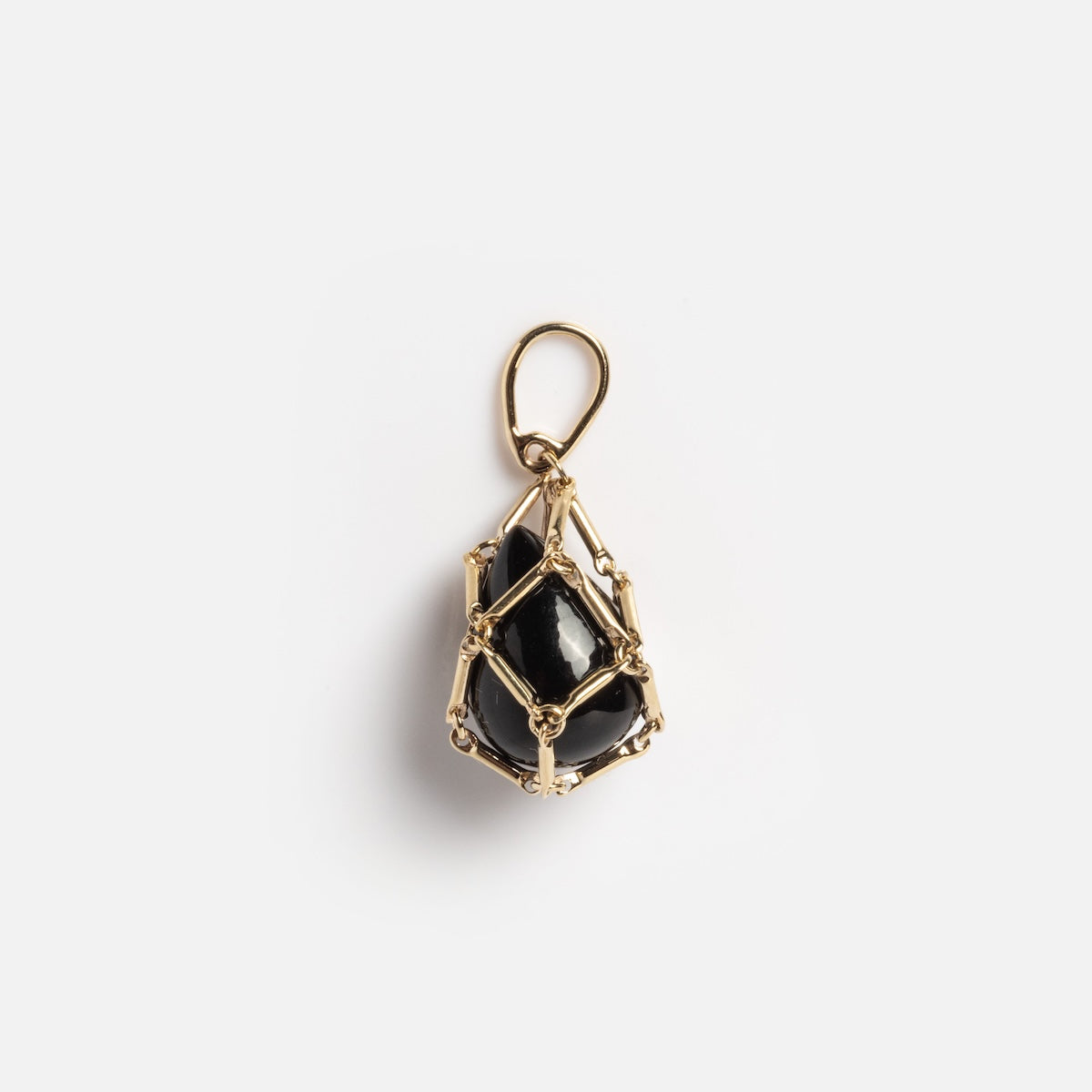 The Solid Gold Tethered Obsidian Charm Sample features a polished black stone encased in gold wire as a pendant with a top loop, shown on a plain white background.