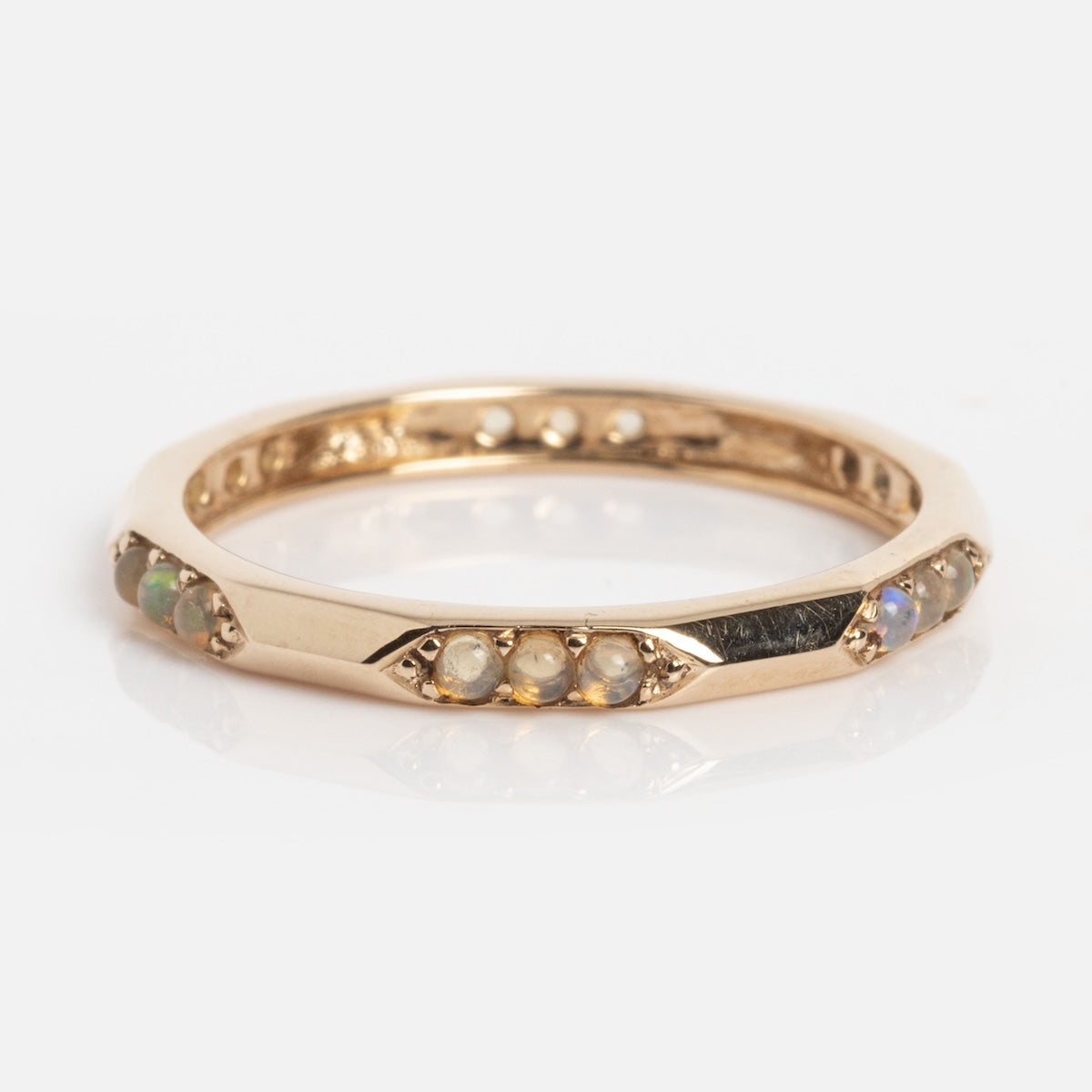 The Dainty Opal Stacking Ring (Sample Size 7) features a 1.5 mm thin 9k solid yellow gold band with alternating small round Ethiopian opals and pearls set delicately around the band.