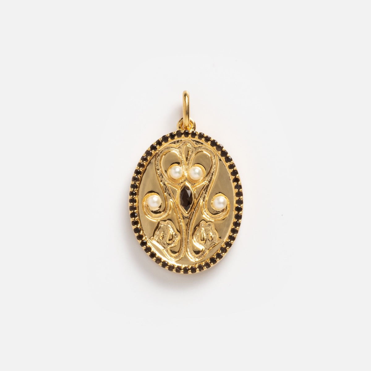 The Pearl Filigree Oval Coin Charm Sample features ornate gold detailing, three small pearls, a central dark gemstone, and a decorative border set against a plain white background.