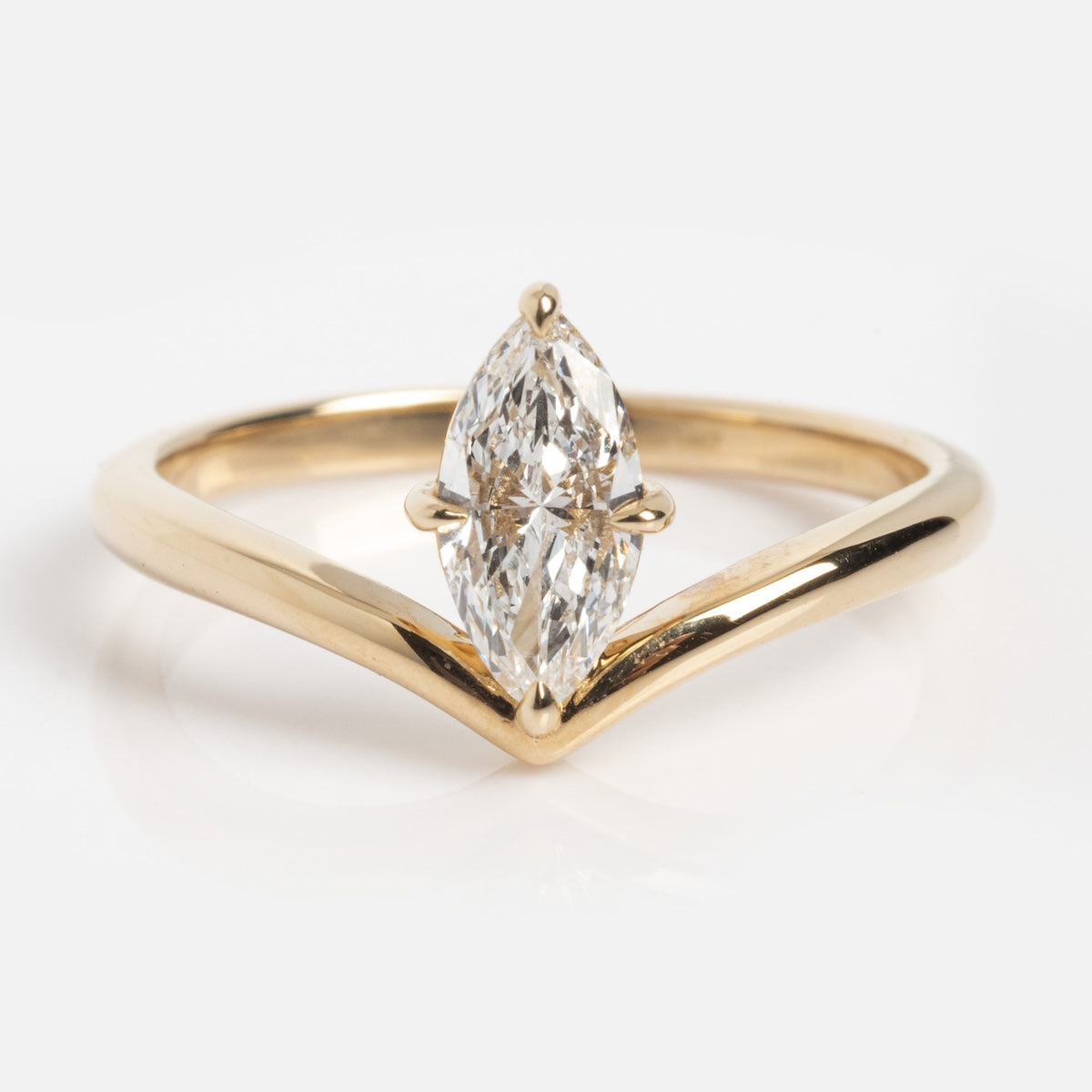 The Solid Gold Floating Solitaire Diamond Ring, sample size 7, features a V-shaped gold band and a vertically set marquise-cut lab diamond at the center, displayed on a plain white background.