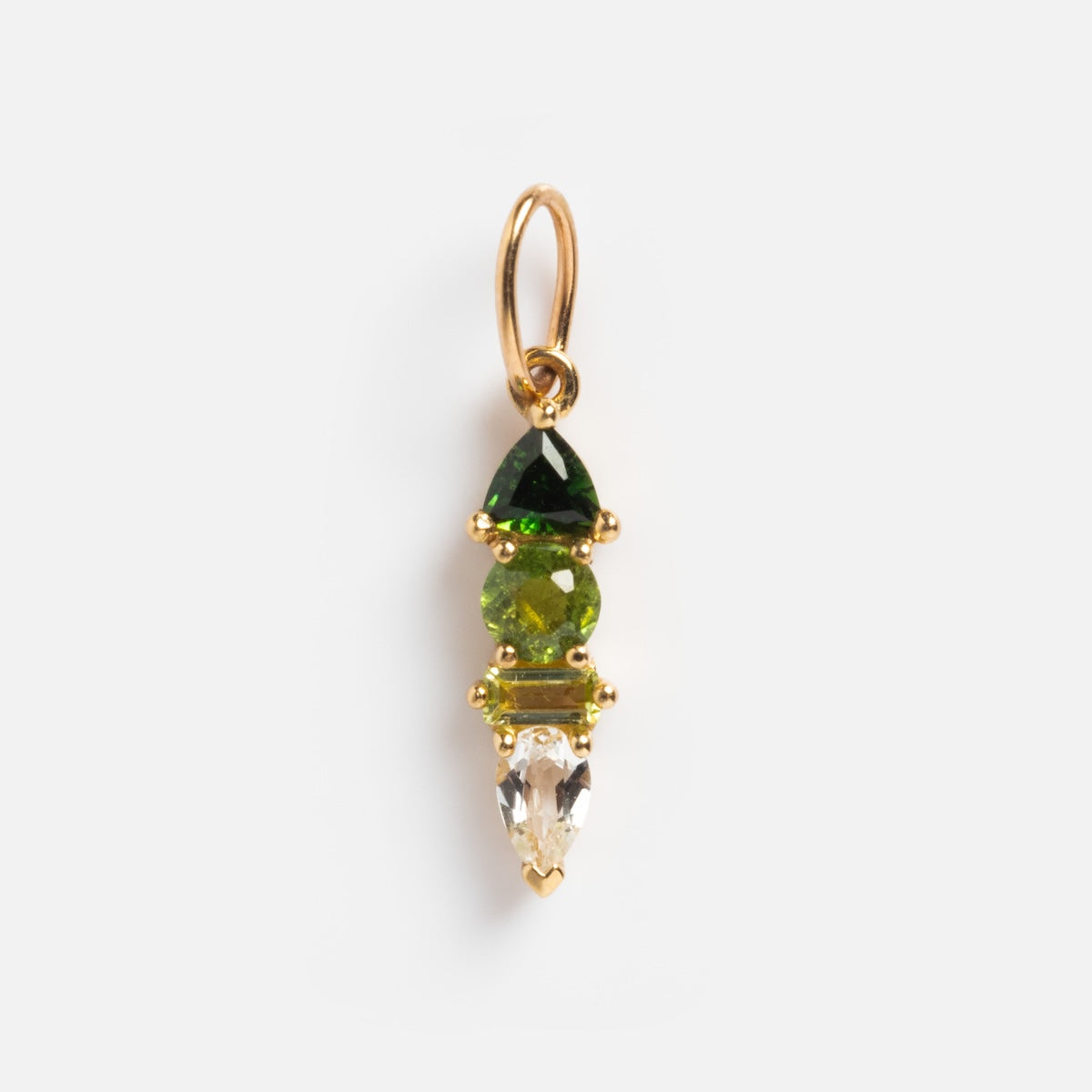The Solid Gold Modern Ombre Birthstone Charm features a gold pendant with three vertically stacked gems: a dark green triangle, a round light green stone, and a clear teardrop, elegantly displayed against a white background.