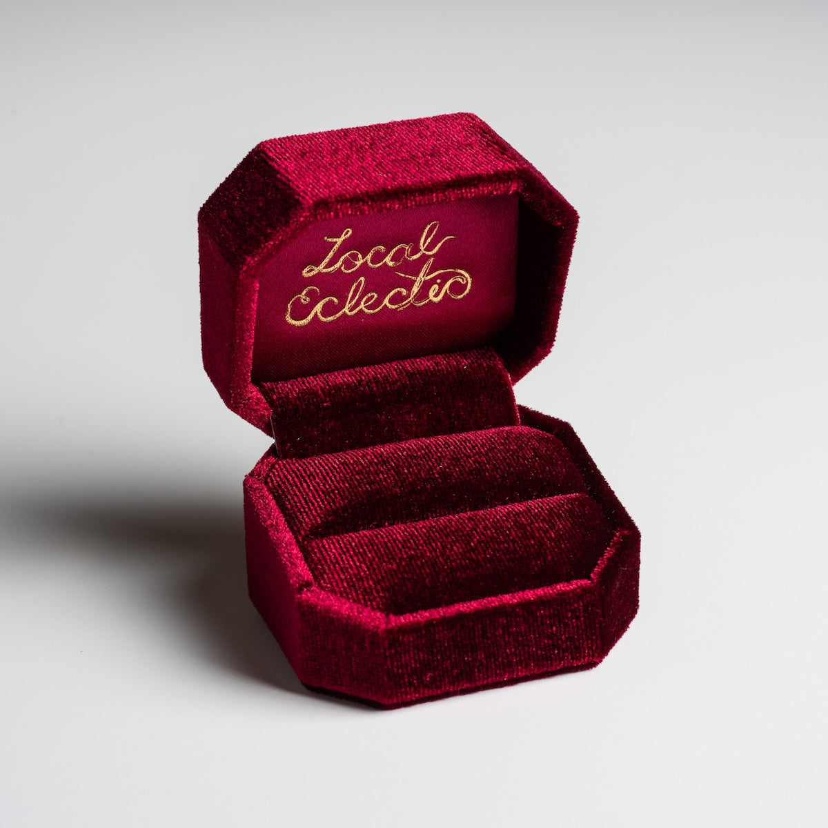 The Fancy Velvet Ring Box features plush red velvet and Local Eclectc in gold script on the inner lid; shown open and empty against a plain background.