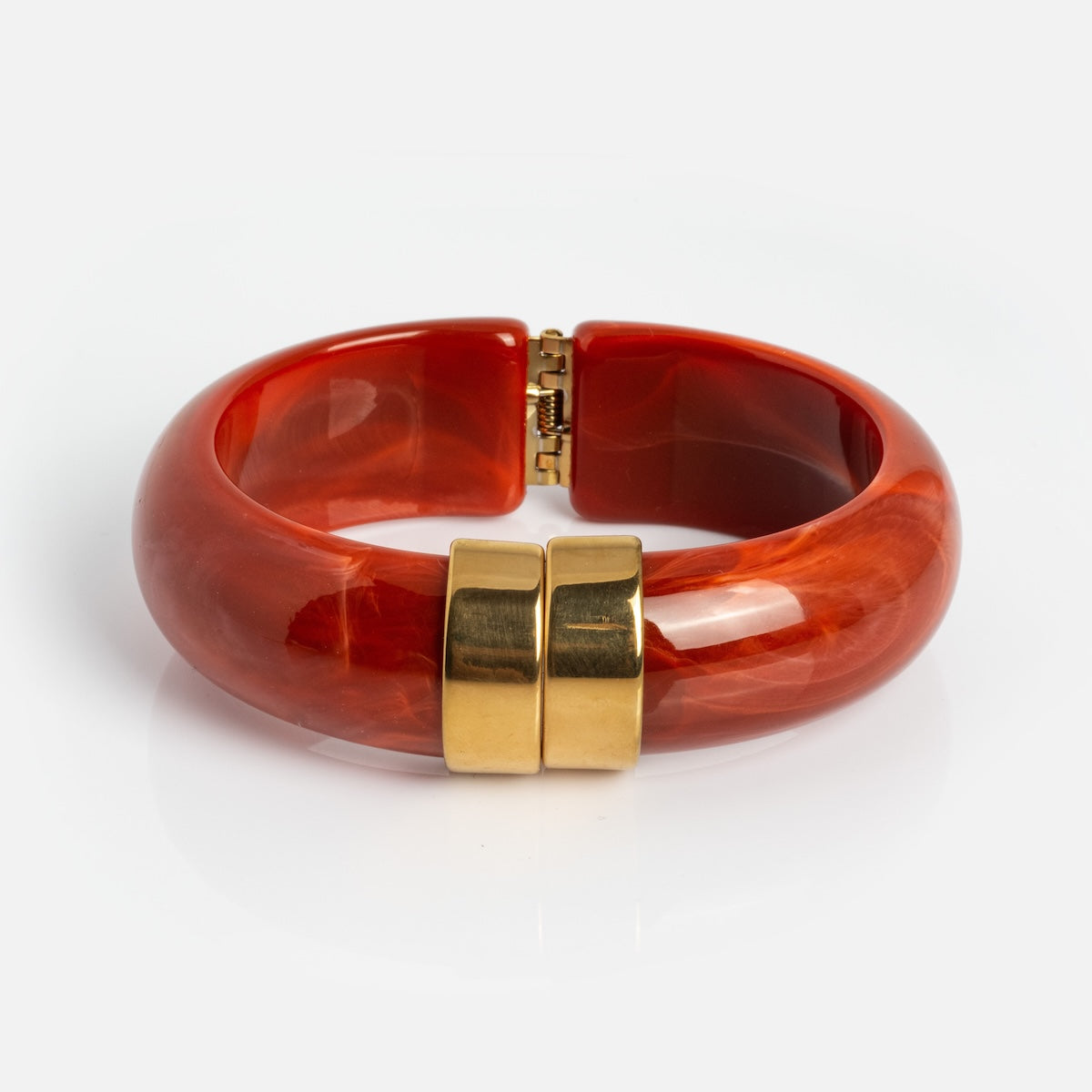The Sylune Bangle Bracelet is a glossy, chunky red hinged bangle with a gold-tone clasp, measuring 22.4 mm, shown on a white background.