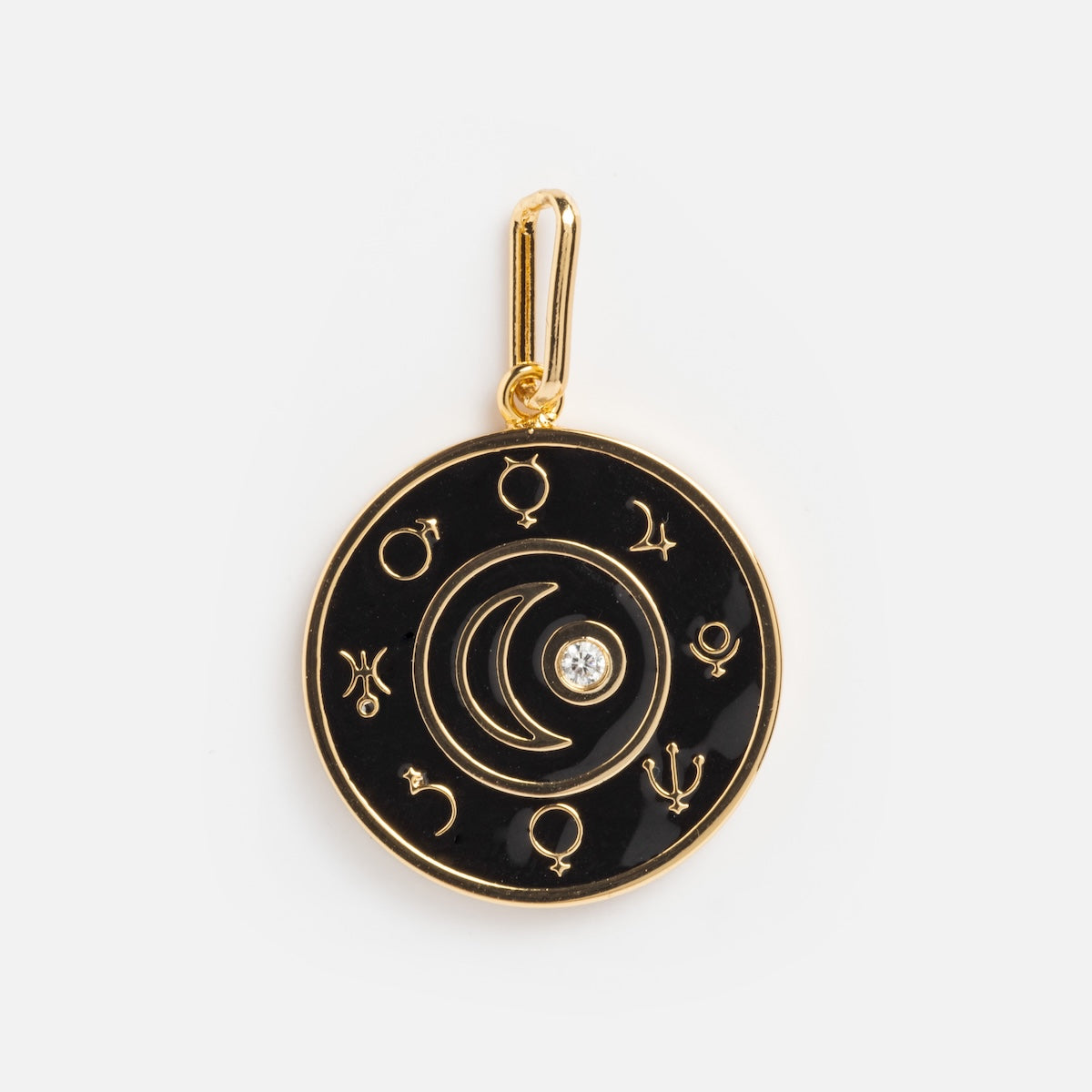 The Charms by Thatch pendant is round and gold-plated, featuring black zodiac symbols around the edge, a crescent moon, and a central sparkling gem. It includes a gold bail for easy attachment to your favorite chain.