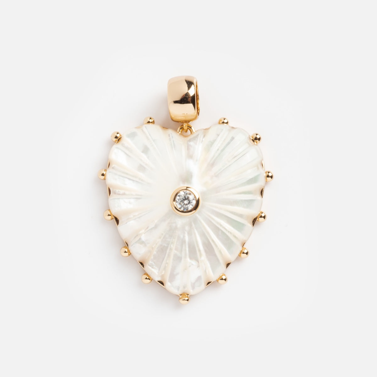 The Charms by Thatch heart-shaped pendant features gold beaded edges, lustrous mother-of-pearl, and a central round diamond accent—an elegant addition to any collection. Shown on a plain white background.