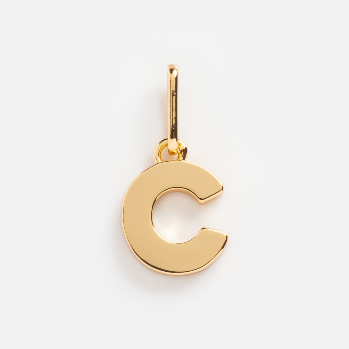 The Be You Initial Charm is a gold letter C pendant with a small loop for attaching to a necklace or bracelet, shown on a plain white background—a stylish personalized jewelry piece.