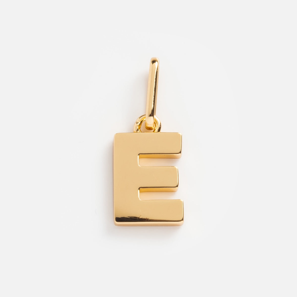 The Be You Initial Charm is a gold pendant shaped like the capital letter E, featuring a top loop for chain attachment—ideal for personalizing your jewelry—shown against a plain white background.