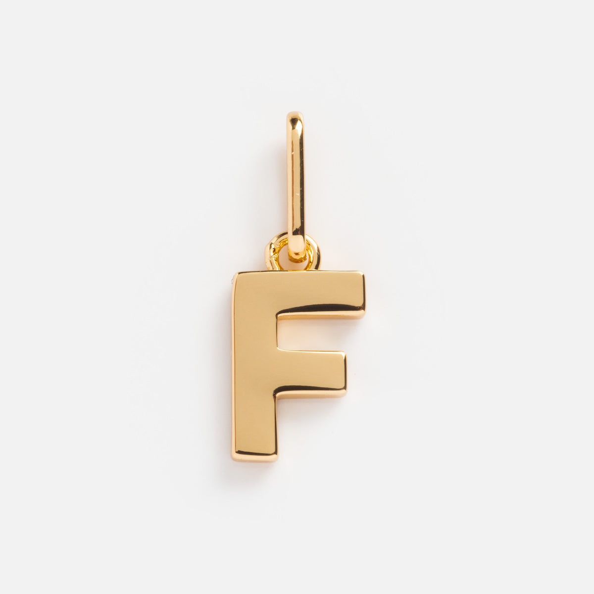 The Be You Initial Charm is a gold pendant shaped like the uppercase letter F, featuring a small loop for easy attachment to necklaces or bracelets. Displayed on a plain white background, its ideal for personalized jewelry.