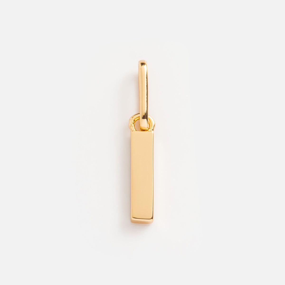 The Be You Initial Charm is a simple gold rectangular bar pendant with a small loop, ideal for personalized jewelry, shown against a plain white background.