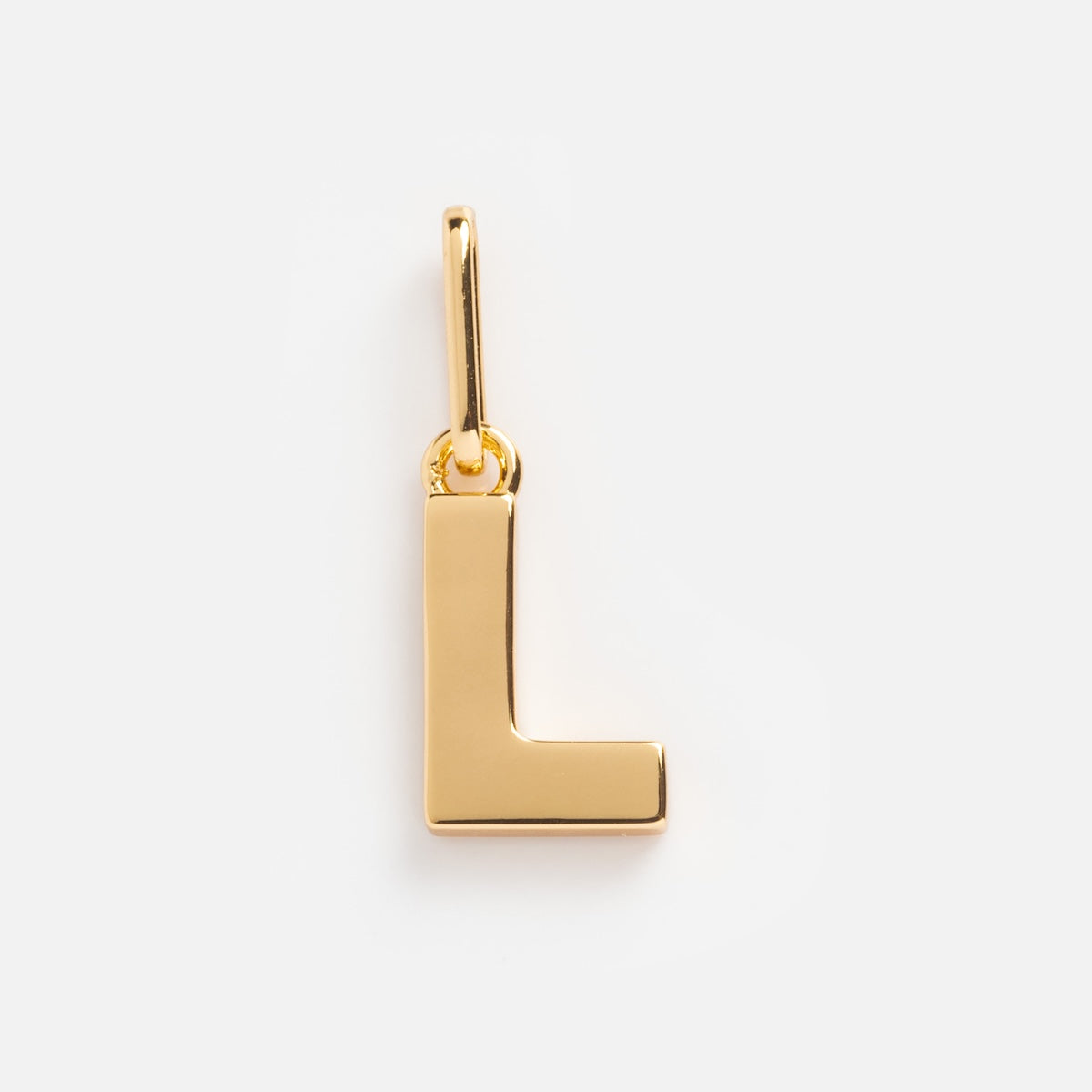 The Be You Initial Charm is a gold pendant shaped like the capital letter L, featuring a small loop at the top for attachment to a necklace or bracelet, shown against a plain white background.