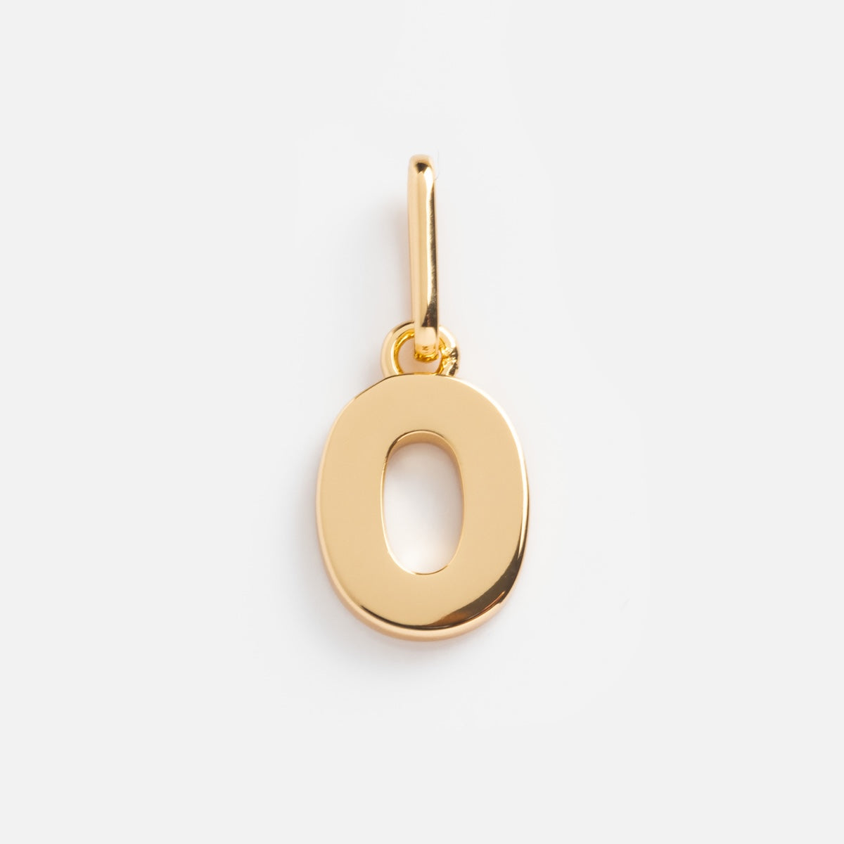 The Be You Initial Charm is a polished gold pendant shaped like the letter O, featuring a small loop for attaching to a chain—ideal for adding personalized jewelry style. Shown against a plain white background.