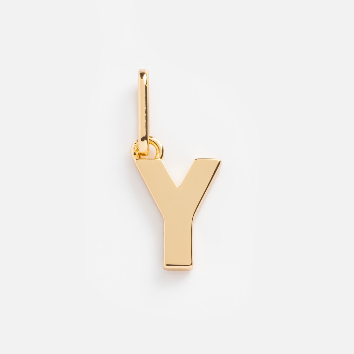 The Be You Initial Charm is a gold pendant shaped like the letter Y, featuring a small top loop for easy attachment to a chain. Ideal for personalized jewelry, its presented on a plain white background.
