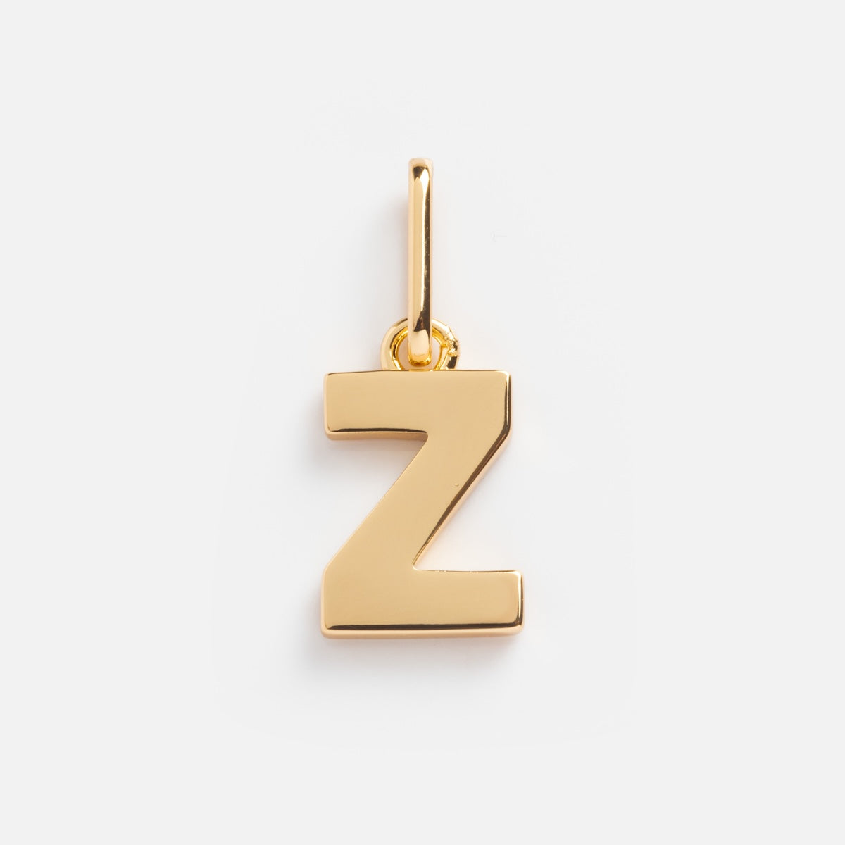 The Be You Initial Charm is a gold Z-shaped pendant with a small loop for attaching to a necklace, adding personalized style. Shown on a plain white background.