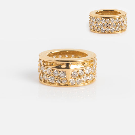 The Solid Gold Spacer Charm is a gold cylindrical ring adorned with three rows of clear, sparkling gemstones, shown in close-up on a white background with a smaller image of the charm in the top right corner.