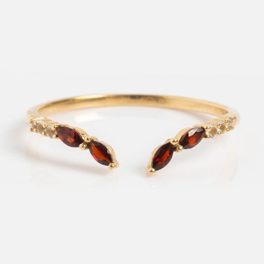 The Solid Gold 2025 January Capsule Delicate Garnet Stacking Ring features a thin open band with three marquise-cut red gemstones on each end—a minimalist garnet ring, perfect for January birthdays or stacking.