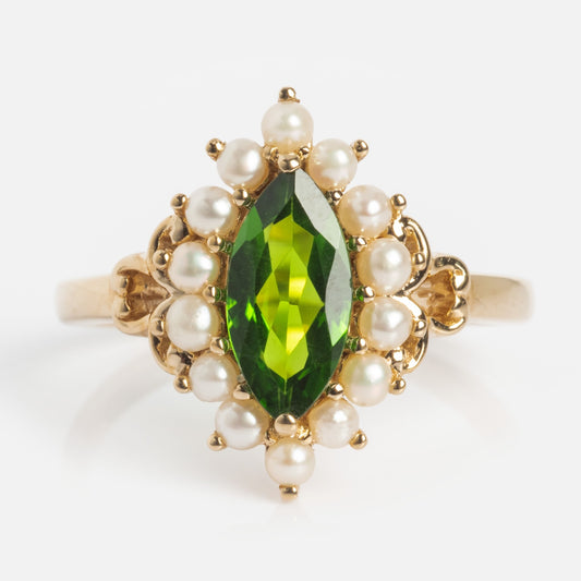 The 14k Opulent Green Diopside and Pearl Marquise Ring features a marquise-cut green diopside center stone accented by a delicate pearl halo for an elegant look.