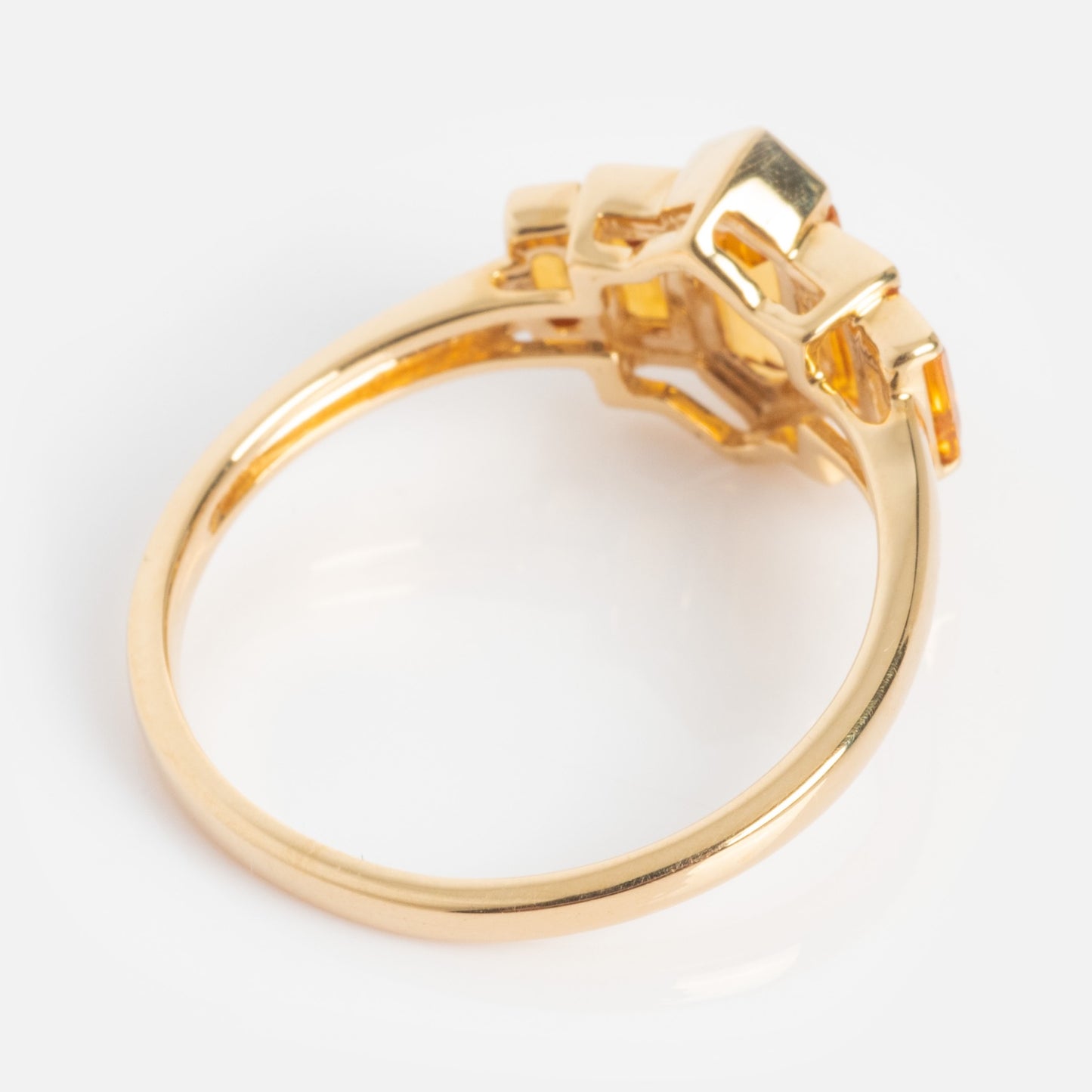The 14k Graduated Citrine Deco Ring features a solid gold art deco design with a detailed, geometric setting, shown from the side on a white background.