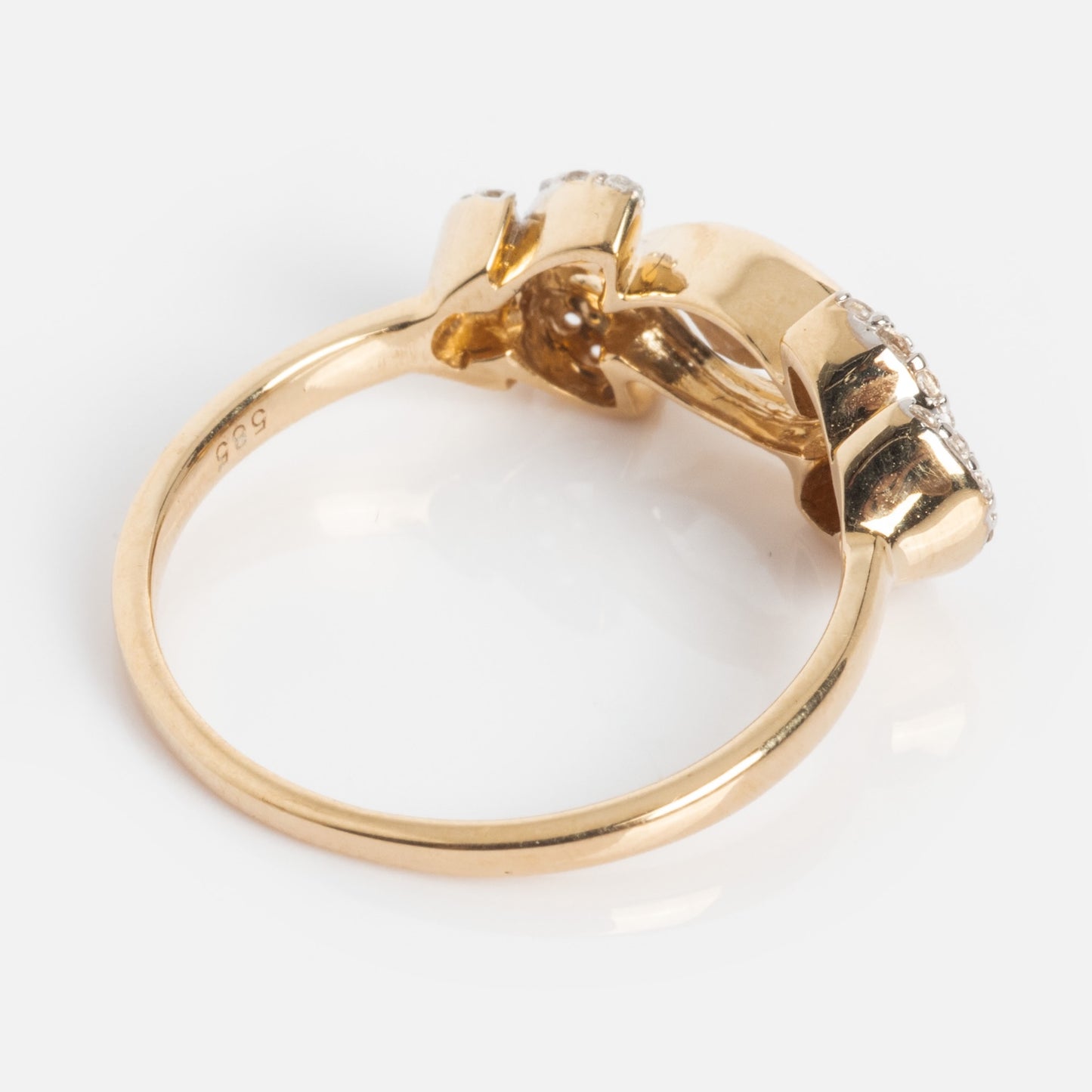 The 14k Vintage Inspired Laurel Crown Ring features solid gold with a unique sculptural design of interlocking shapes and small embedded gems, shown from the side against a plain white background.