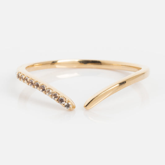 The 14k White Sapphire Open Front Nesting Ring features a delicate row of sparkling sapphires on one side and a smooth band on the other, beautifully displayed on a white background.