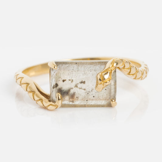The Solid Gold Labradorite Serpent Ring for Protection features a coiling band with detailed head and scales, symbolizing protection, and a rectangular, speckled labradorite stone centerpiece.