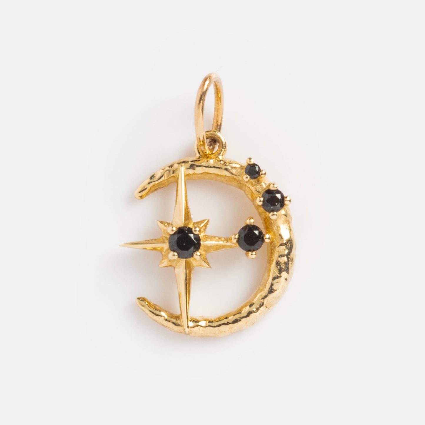 The Solid Gold Amulet Charm features a crescent moon design with three black stones and a central star-set gemstone. It comes with a loop for easy attachment to your favorite chain. Exclusively from Local Eclectic.