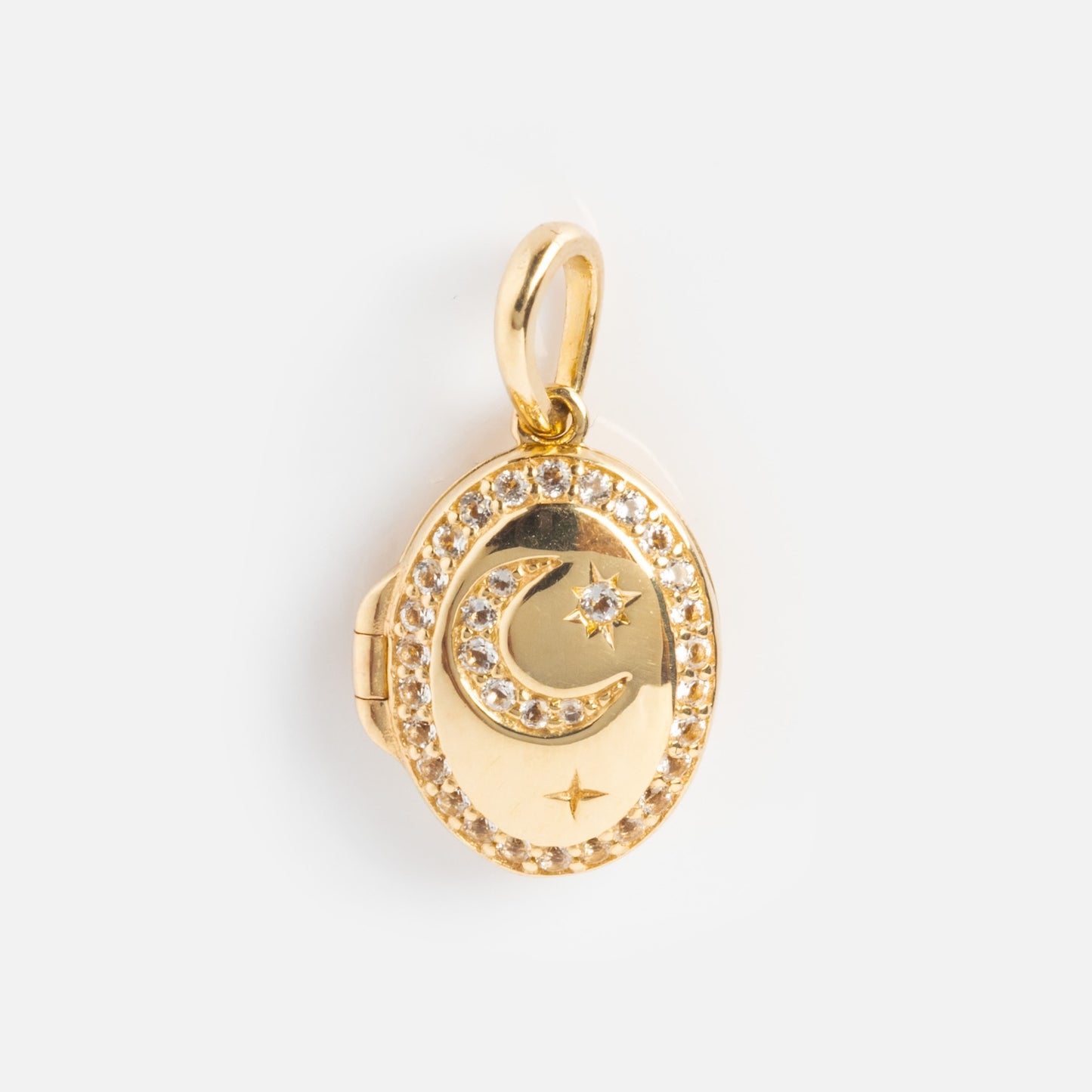 The Solid Gold Amulet Charm is an oval locket pendant adorned with crystals and a crescent moon and star design, surrounded by gemstones—an exclusive necklace from Local Eclectic, shown on a plain white background.