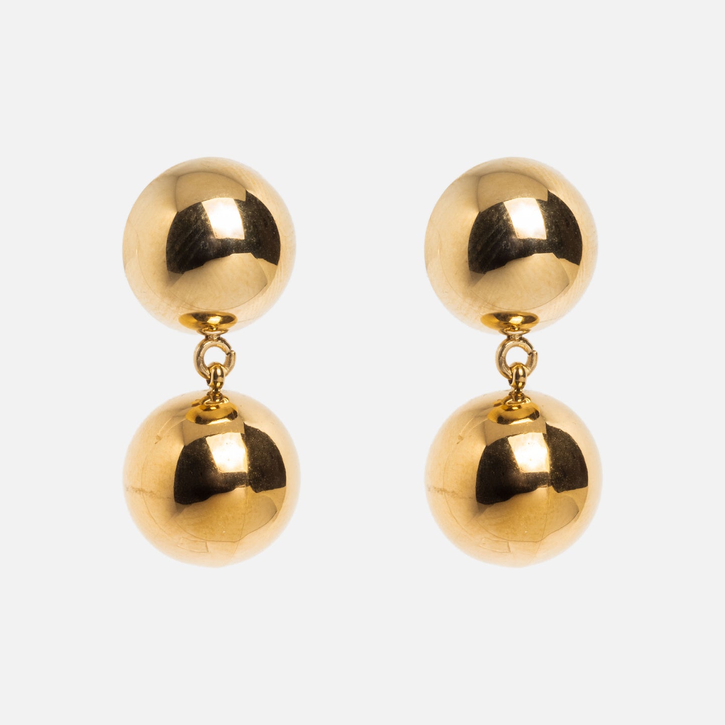 C'est La Vie Earrings are 14k gold plated drop earrings with two shiny, spherical beads linked together, creating a classic look against a white background.