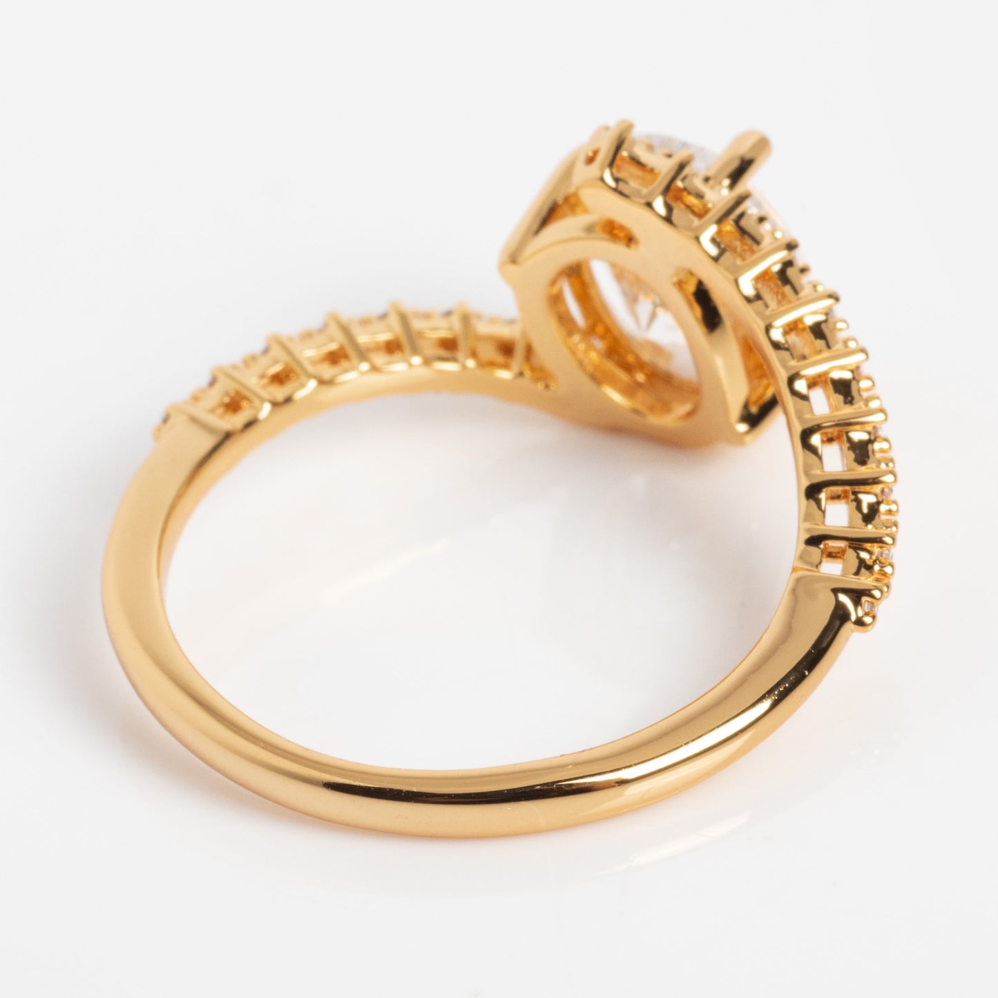 The Tilted CZ Ring features a unique open gold band with a row of small square cubic zirconia stones along the top and a raised rectangular setting, displayed against a white background.