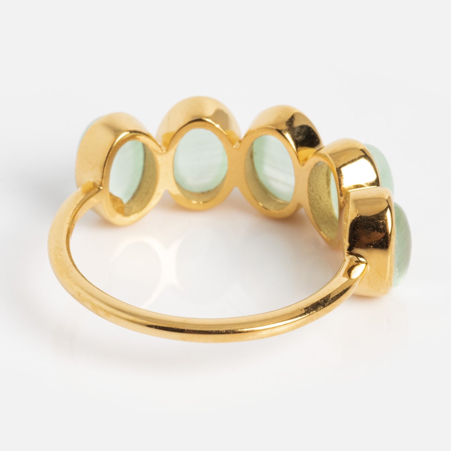 The Sky Blue Cats Eye Flow Ring features five oval, sky blue cat's eye gemstones set in a row, displayed on a white background.