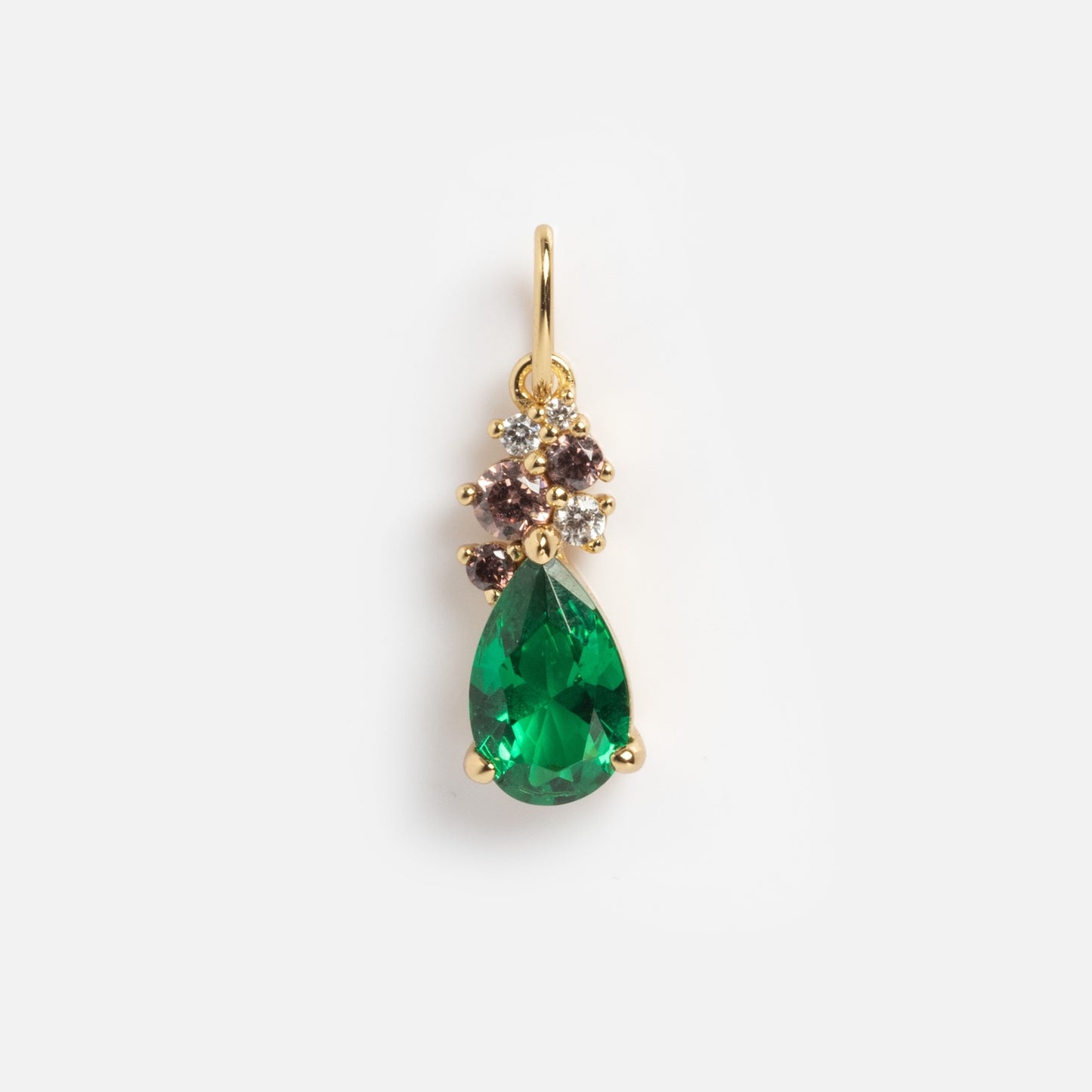 The Vintage Inspired Pendant Charm is a gold pendant with a large teardrop green gemstone, accented by clusters of small clear and brown stones, shown on a plain white background.