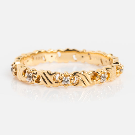 The Solid Gold Vintage Inspired Sapphire Floral Band features a scalloped gold band with twisting clusters of sapphires in a delicate floral design, showcased on a white background.