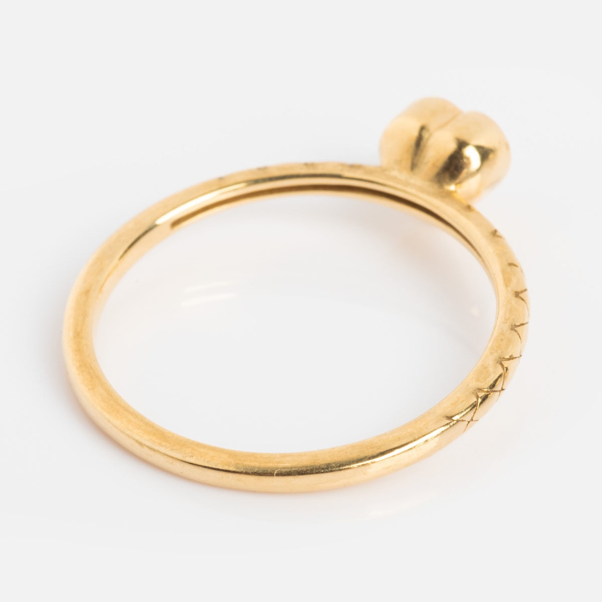 The Solid Gold Pink Amethyst Heart Ring from Family Gold features a smooth gold band with a heart-shaped pink amethyst stone at the center, shown on a white background.