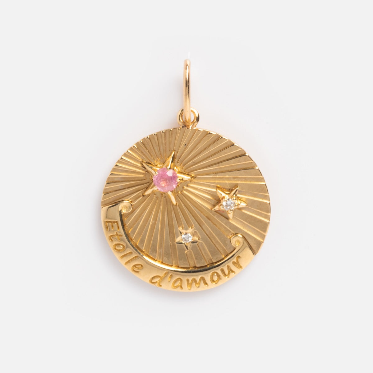 Exclusive to Local Eclectic, the Solid Gold Coin Charm is engraved with Étoile damour and features one pink and two clear star-shaped gems set on a radiating textured background.