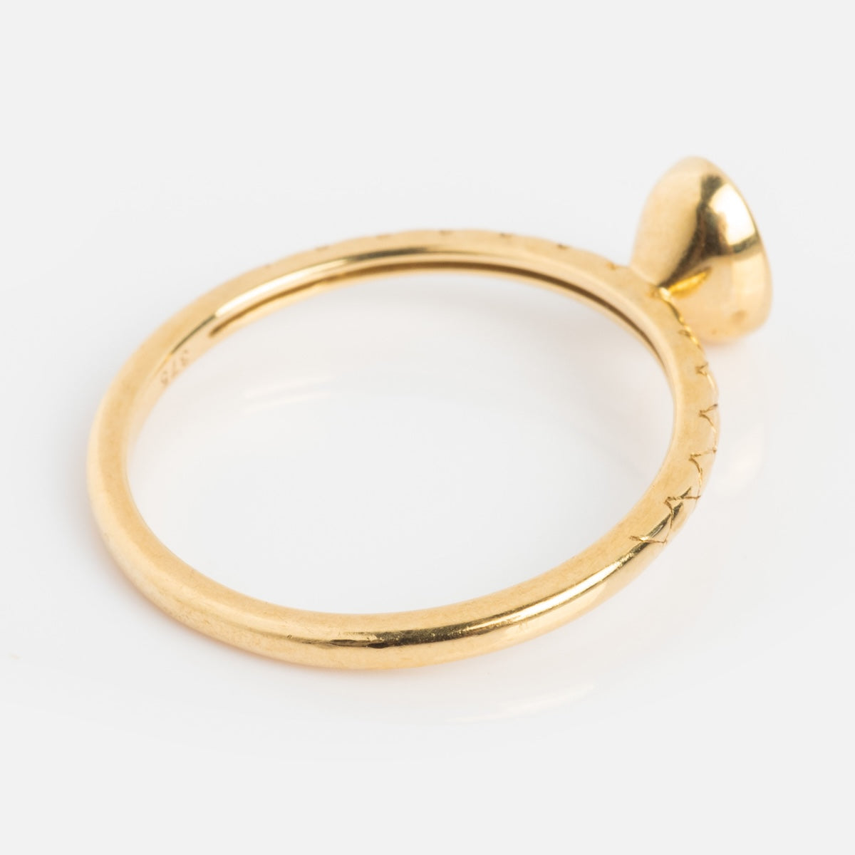 The Solid Gold Amethyst Oval Ring features a sleek, minimalist gold band with an oval amethyst accent, shown against a simple white background.