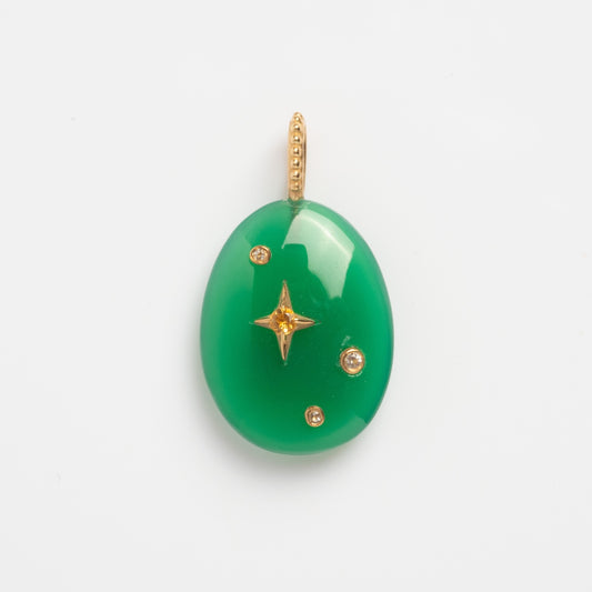 The Solid Gold Zodiac Constellation Crystal Charm is a green oval gemstone pendant with a gold beaded loop, gold star accent, and three gold details—ideal personalized zodiac jewelry—shown on a plain white background.
