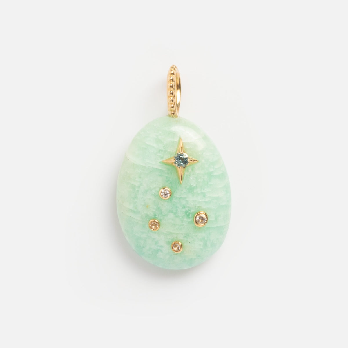 A light green, egg-shaped Solid Gold Zodiac Constellation Crystal Charm features a gold loop, a gold star, and five small round gemstones—an elegant piece of personalized zodiac jewelry.